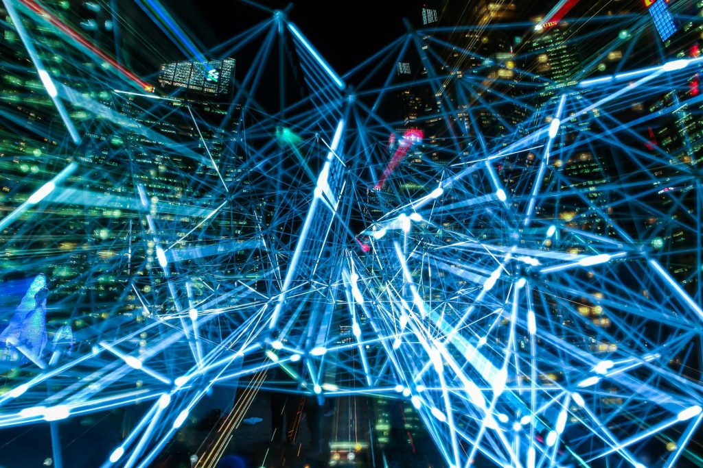 Built to Scale Globally Dynamic urban scene showcasing interconnected light trails representing digital communication networks.